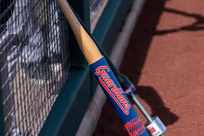 Mar 25, 2022; Scottsdale, Arizona, USA; A warm-up bat with the new branding for the Cleveland Guardians rests on the dugout fencing during spring training against the San Francisco Giants at Scottsdale Stadium. Mandatory Credit: Allan Henry-USA TODAY Sports